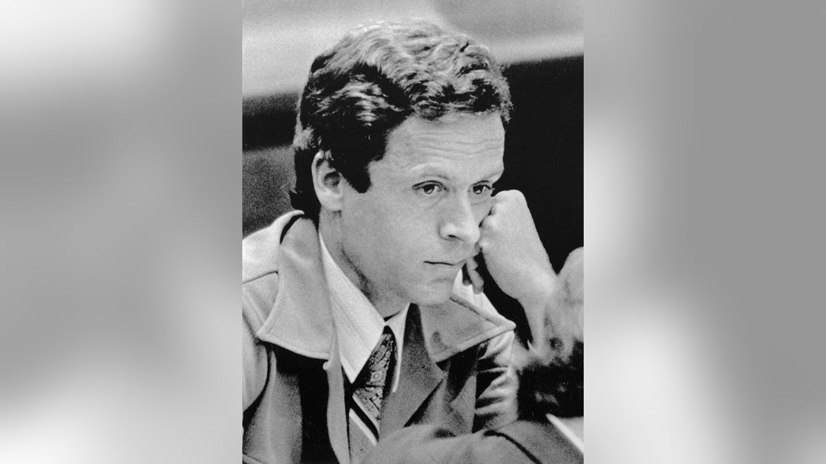 Ted Bundy resting his head on his fist.