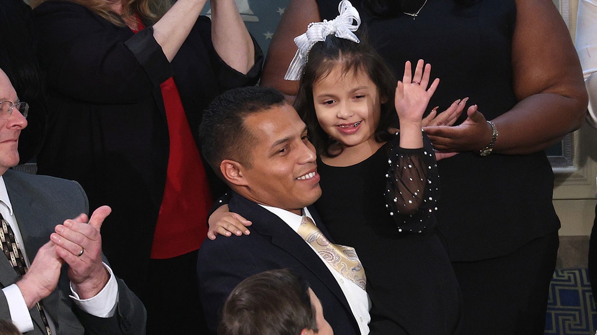 Marcus Coleman holds his daughter Dalilah Coleman