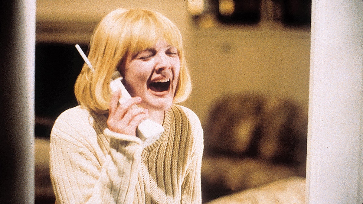 A scene from "Scream" where Drew Barrymore is on the phone crying.